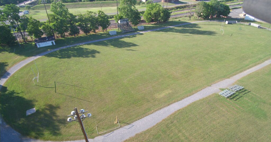 ariel photo of a gravel track with metal bleachers
