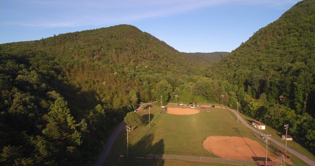 ariel photo of softball field surrounded by mountains and trees